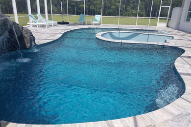 Pool fountain - indoor decomposed granite and custom-shaped pool fountain idea in Tampa