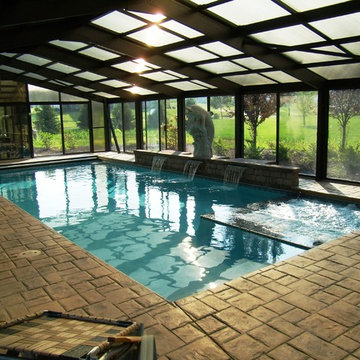 Indoor pool with raised wall and sheer descent waterfalls in Williams Township