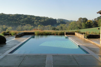 Inspiration for a timeless backyard stamped concrete and rectangular pool remodel in Philadelphia