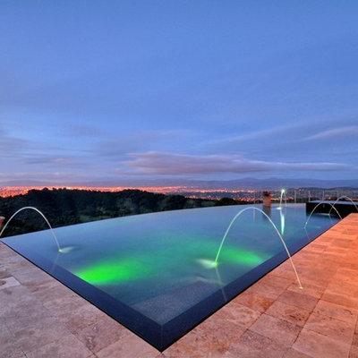 Mid-sized trendy backyard rectangular and stone infinity pool fountain photo in San Francisco