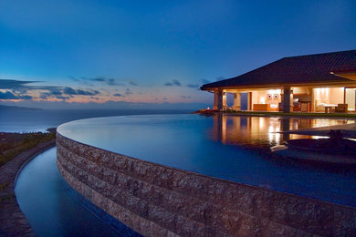Pool fountain - huge tropical backyard tile and custom-shaped infinity pool fountain idea in Hawaii