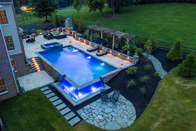 Infinity edge swimming pool, fireplace and travertine patio.