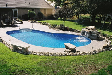 Mid-sized elegant backyard concrete and kidney-shaped pool fountain photo in Baltimore
