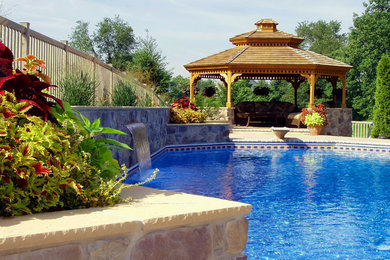Example of a mid-sized tuscan backyard custom-shaped lap pool fountain design in Other