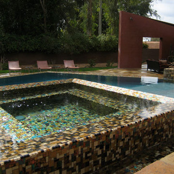 Iridescent mosaics shimmer under water in this beautiful infinity edge spa.
