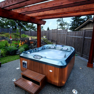 This is an example of a small modern backyard custom-shaped aboveground pool in Las Vegas with a hot tub and decomposed granite.