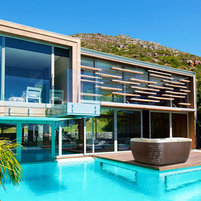 Inspiration for a mid-sized contemporary backyard rectangular aboveground hot tub remodel in Portland with decking