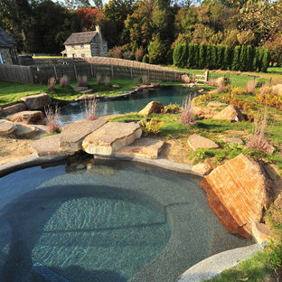Large mountain style backyard stone and custom-shaped natural pool house photo in Philadelphia