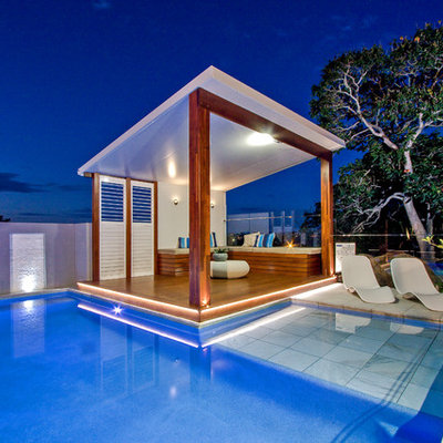 Inspiration for a mid-sized modern backyard stone and custom-shaped aboveground pool house remodel in Brisbane