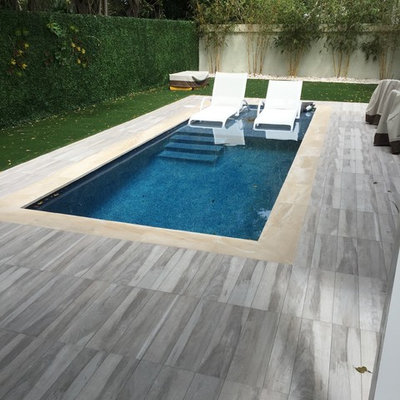 Inspiration for a small contemporary backyard rectangular and tile lap pool remodel in Miami