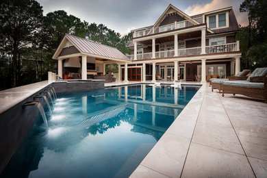 Pool house - large contemporary backyard stone and custom-shaped aboveground pool house idea in Charleston