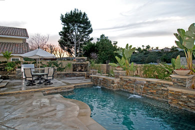 Island style pool photo in Orange County