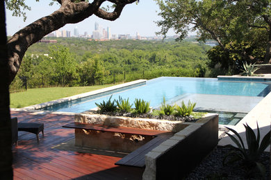 Hot tub - large contemporary backyard concrete paver and l-shaped lap hot tub idea in Austin