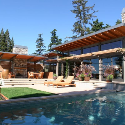 Large trendy backyard concrete paver and rectangular lap hot tub photo in Seattle