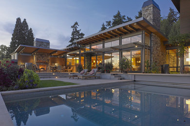 Example of a large trendy backyard concrete paver and rectangular lap pool design in Seattle