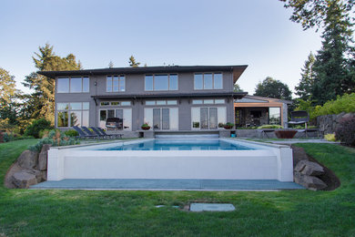 Inspiration for a large contemporary backyard rectangular infinity pool remodel in Portland