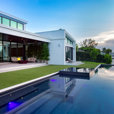 Inspiration for a contemporary backyard custom-shaped lap hot tub remodel in Miami
