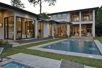 Inspiration for a large contemporary backyard rectangular and concrete lap pool fountain remodel in Houston