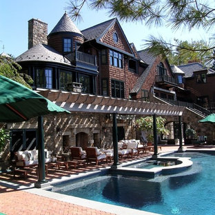 Inspiration for a victorian custom-shaped pool in New York with brick pavers.
