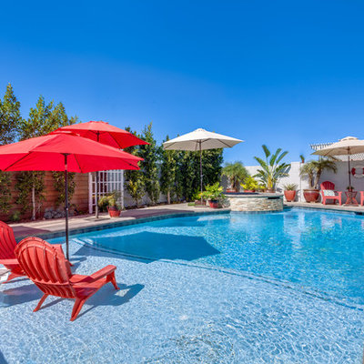 Hot tub - transitional concrete paver and custom-shaped hot tub idea in Orange County