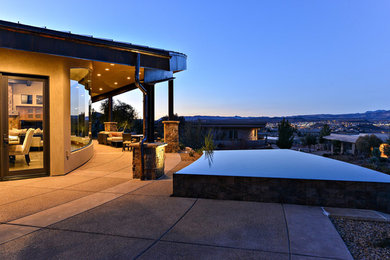 Inspiration for a large contemporary backyard concrete and custom-shaped infinity pool remodel in Salt Lake City