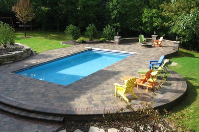 Pool fountain - large modern backyard rectangular aboveground pool fountain idea in Other