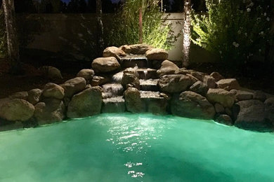Inspiration for a large mediterranean back custom shaped natural swimming pool in Sacramento.