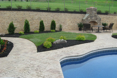 Inspiration for a large timeless backyard stone and custom-shaped lap pool remodel in Charlotte