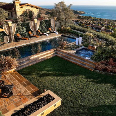 Hot tub - large mediterranean backyard rectangular lap hot tub idea in Orange County