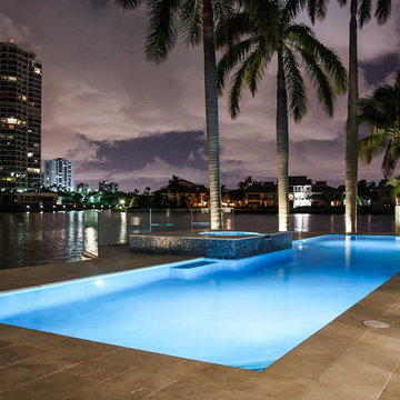 Lap Pool Classic Straight Edge Design With a Raised Spa at Night in Aventura, Fl