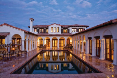 Example of a tuscan courtyard rectangular pool design in Portland