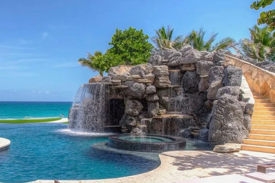 Large island style pool photo in Miami