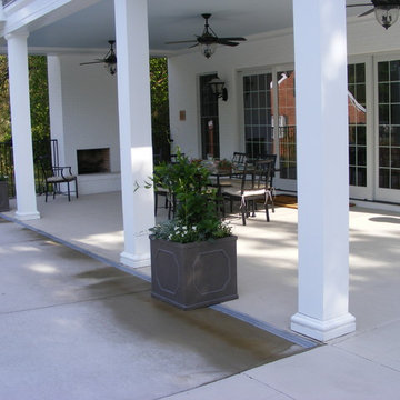 Large planters buffer the transition from pool deck to dining porch of poolhouse