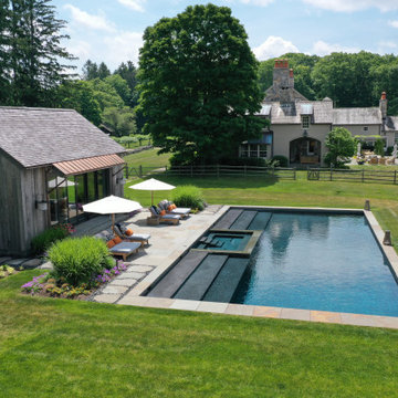 large rectangular pool with oversized steps + interior spa