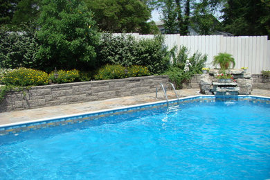 Example of a mid-sized classic backyard tile and rectangular pool design in Cincinnati