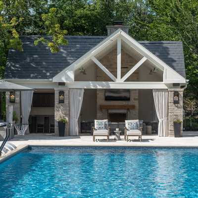 Inspiration for a huge timeless backyard stone and rectangular pool house remodel in Chicago