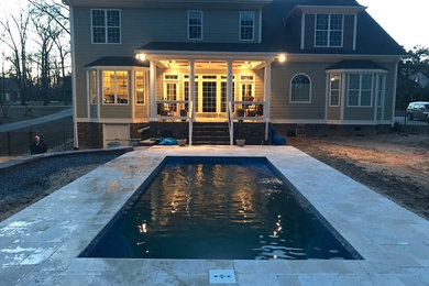 Pool - mid-sized backyard stone pool idea in Raleigh