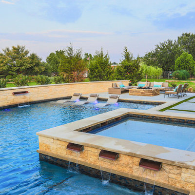 Example of a large trendy backyard concrete and l-shaped pool fountain design in Dallas