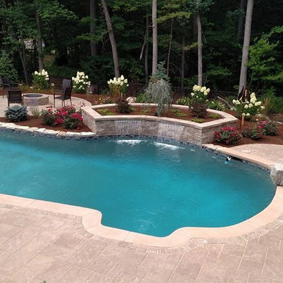 Inspiration for a mid-sized craftsman backyard concrete paver and custom-shaped natural pool fountain remodel in Boston