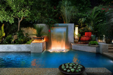 Pool fountain - mid-sized tropical backyard rectangular lap pool fountain idea in Los Angeles