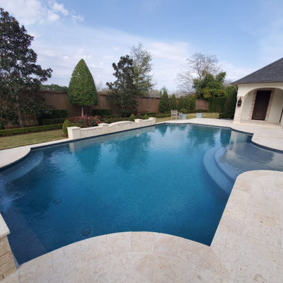 Example of a mid-sized tuscan backyard tile and custom-shaped lap pool fountain design in Houston