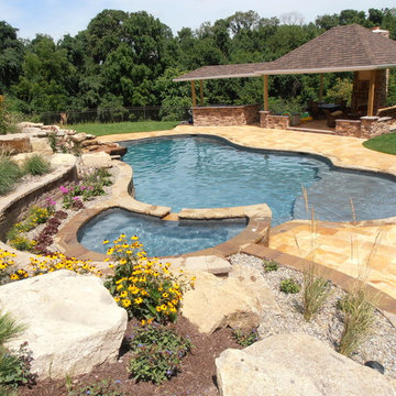 Lowhill Township custom pool with sunshelf, slide, waterfall, & raised spa