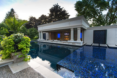 Pool - traditional backyard stone pool idea in Toronto