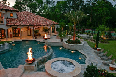 Inspiration for a mediterranean back infinity hot tub in Houston with tiled flooring.