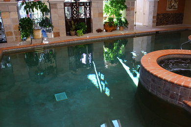 Inspiration for a large mediterranean indoor pool remodel in Denver