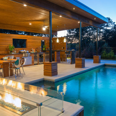 Large minimalist backyard stamped concrete and rectangular pool house photo in Atlanta