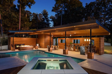 Inspiration for a large modern backyard stamped concrete and rectangular pool house remodel in Atlanta