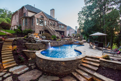 Inspiration for a huge tropical backyard natural pool remodel in Atlanta