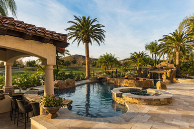 Pool - tropical backyard tile and custom-shaped lap pool idea in San Diego