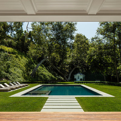Example of a classic backyard rectangular pool house design in Los Angeles